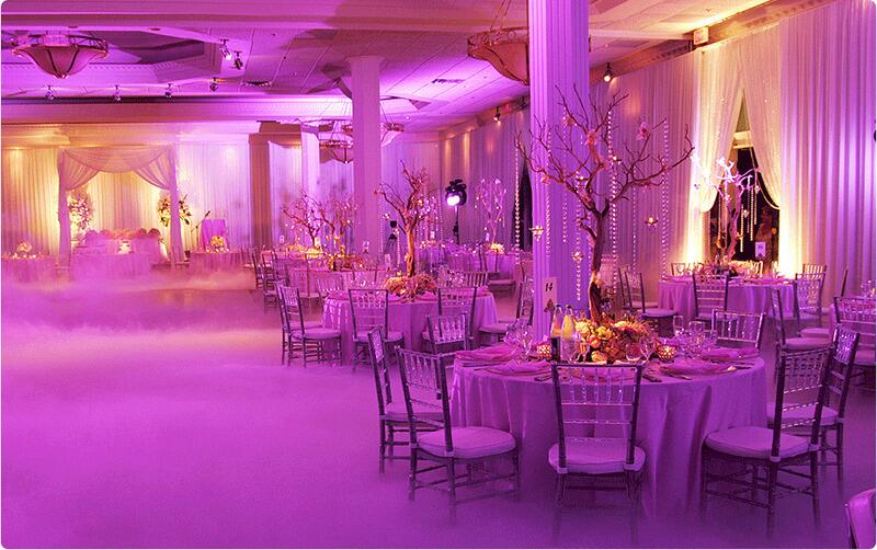 Beautiful indoor wedding setup with Chrystal cushioned chiavari chairs and fog machine on dance floor